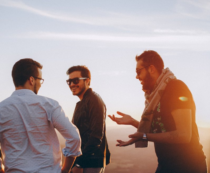 Illustrative image: two friends talking outdoors at sunset